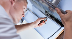 Man Doing Electrical Repairs On Appliance