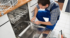 Man repairing open dishwasher